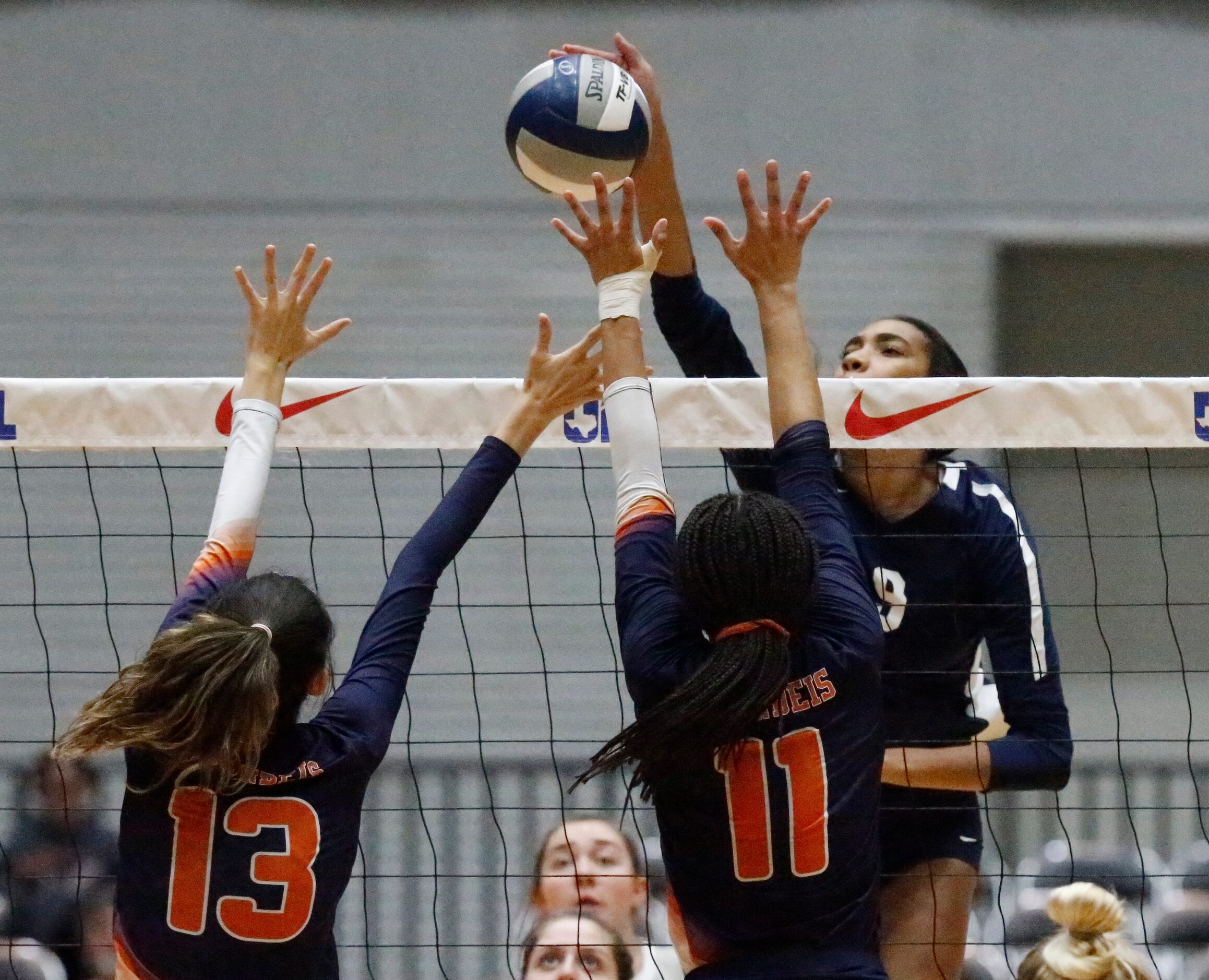 Keller middle Leah Ford (9) gets a hit over Northside Brandeis Middle Sophia Kuyn (13) and...