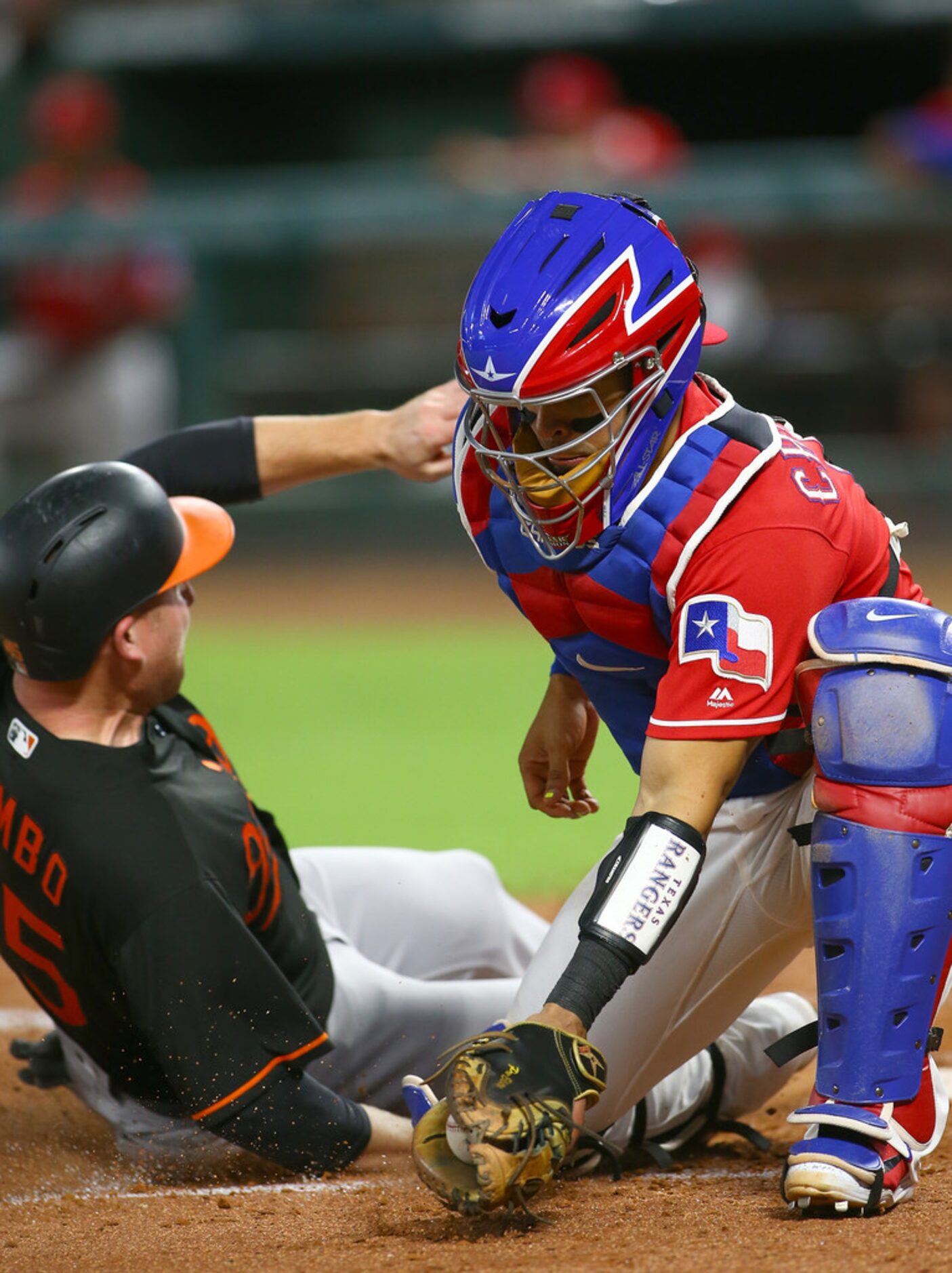 ARLINGTON, TX - AUGUST 03: Robinson Chirinos #61 of the Texas Rangers misses the tag on Mark...