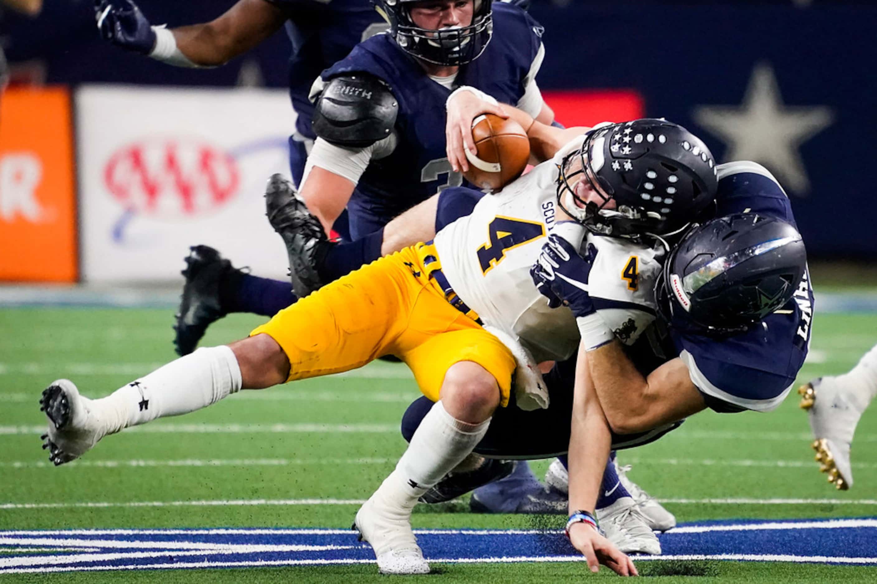 Highland Park quarterback Chandler Morris (4) is brought down by Frisco Lone Star linebacker...