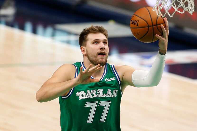 Dallas Mavericks guard Luka Doncic (77) attempts a layup in a game against the Charlotte...