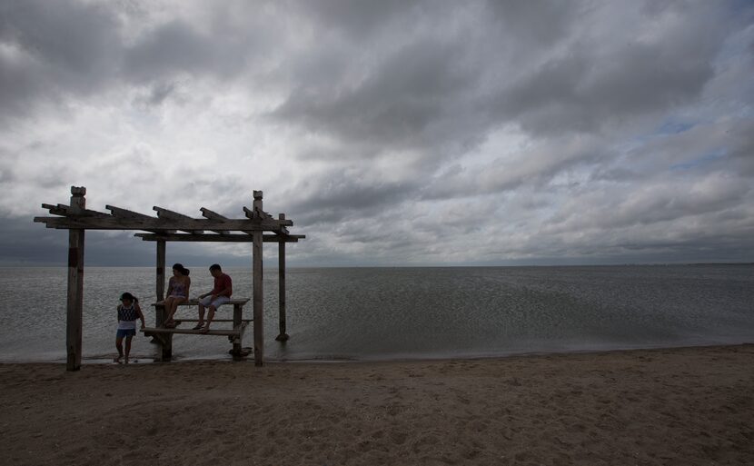 Jenny E Phan, (left), 9, Tri Phan and Van Phan visited North Beach on Tuesday in Corpus...