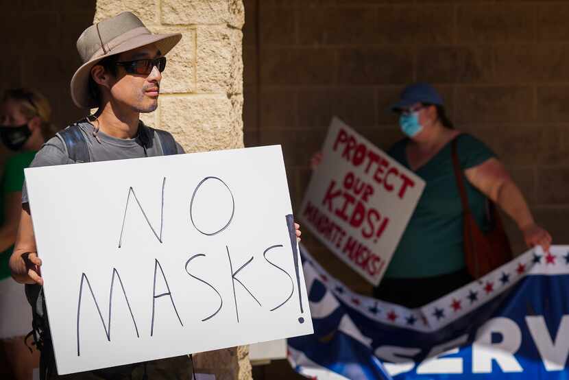Opponents and supporters of mask mandates rallied outside before a Carroll ISD board meeting...