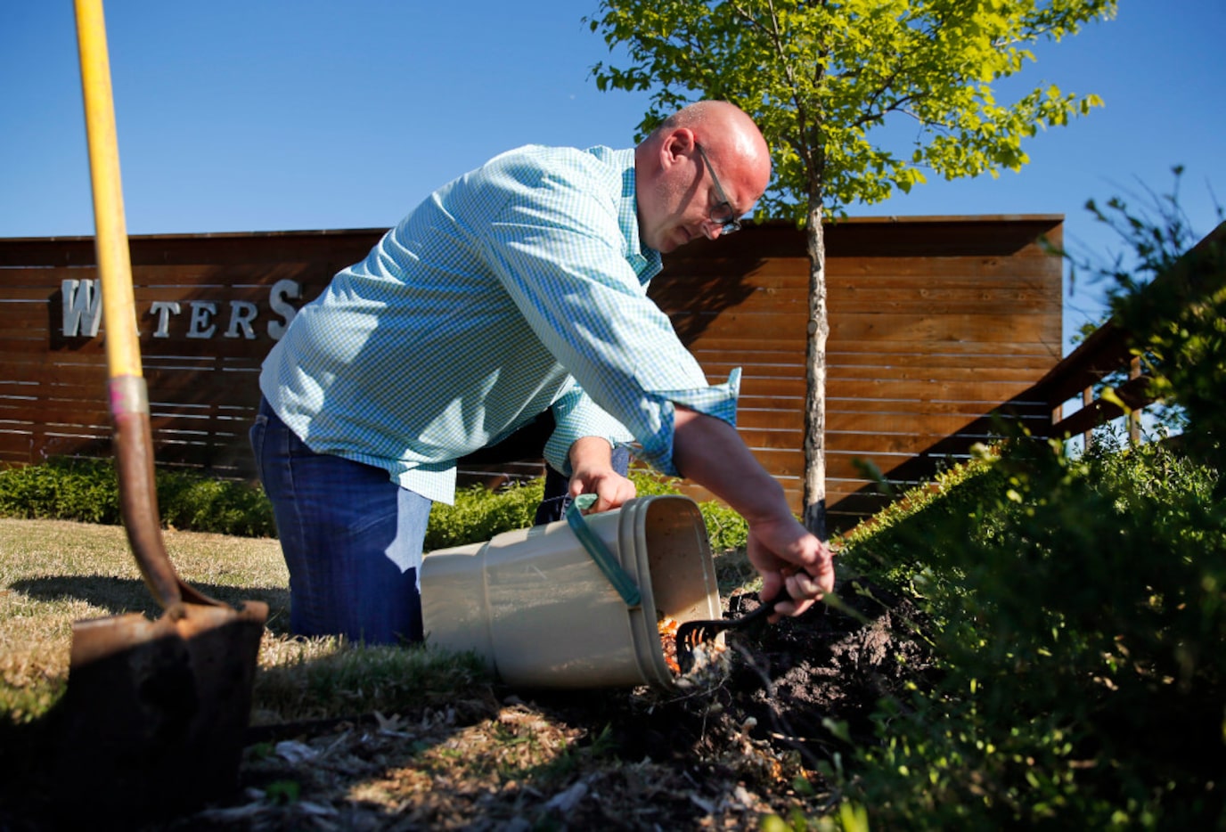 After two weeks of fermentation, horticulturalist Daniel Cunningham adds part of bokashi...