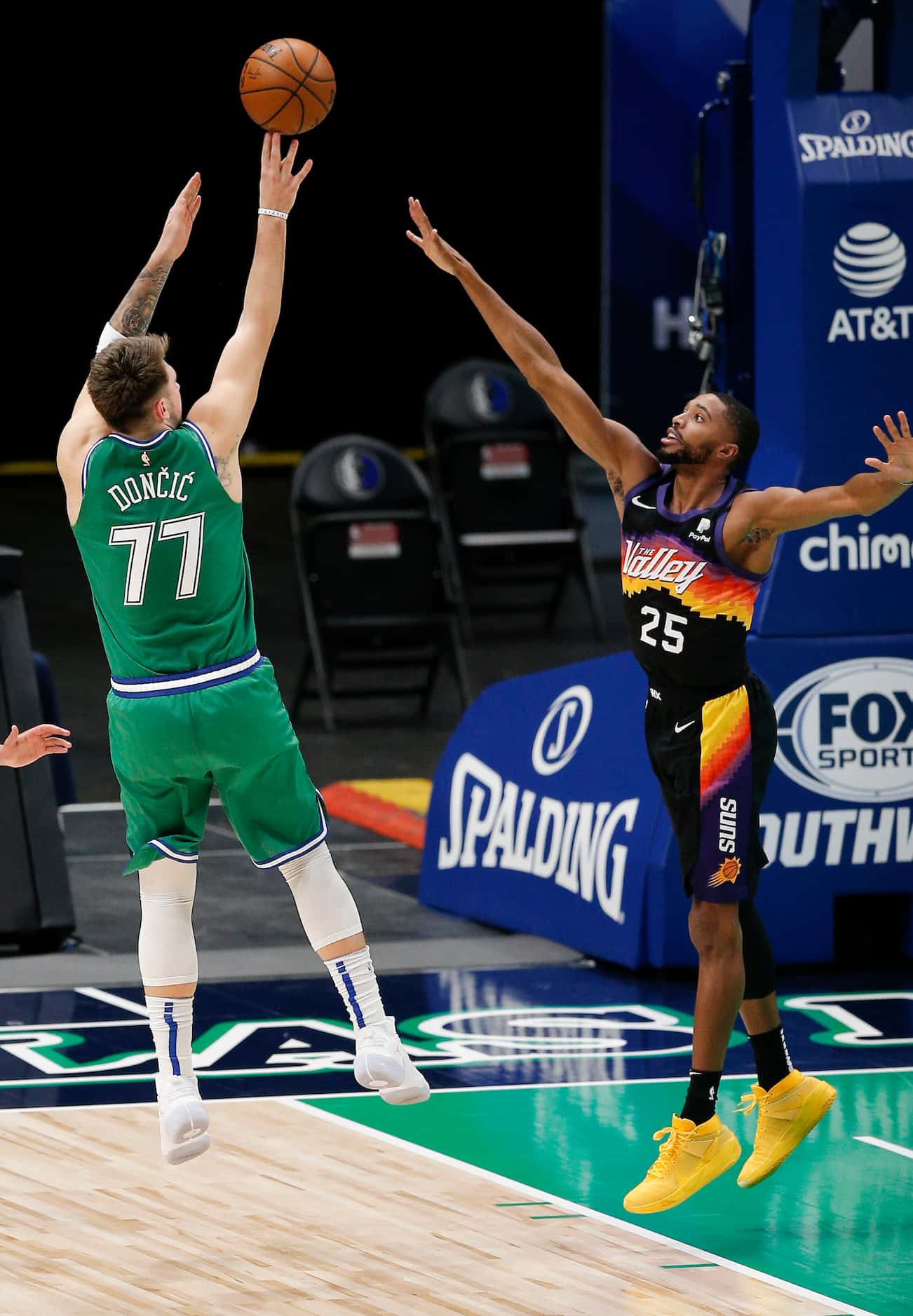 Dallas Mavericks guard Luka Doncic (77) attempts a shot as Phoenix Suns forward Mikal...