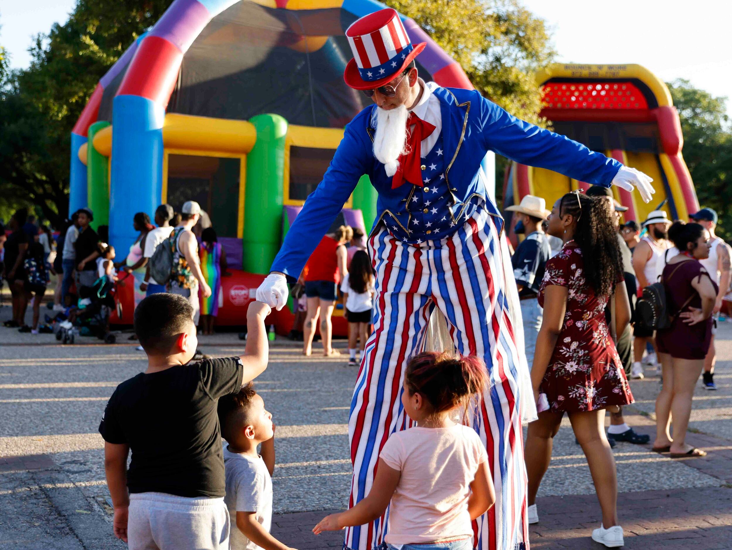 Anthony dressed as “Uncle Sam” fist bumps kids during an Independence Day celebration on...