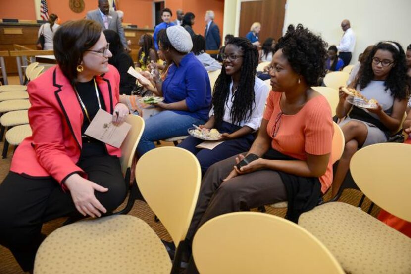 
Billie Ballengee (left), Cedar Hill ISD board member, talks to Sigi Deleawe and her mother,...