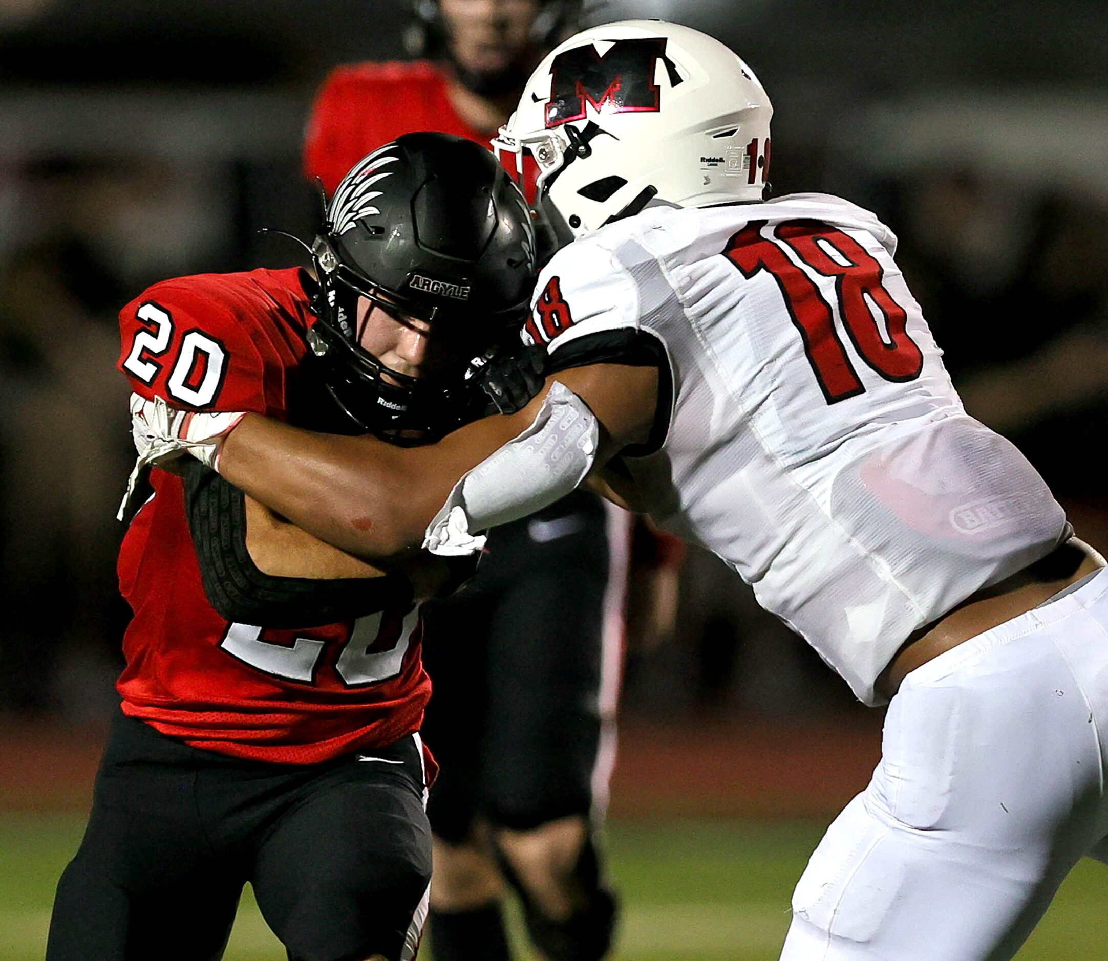 Argyle running back Landon Ferris (20) tries to push his way for a first down against...