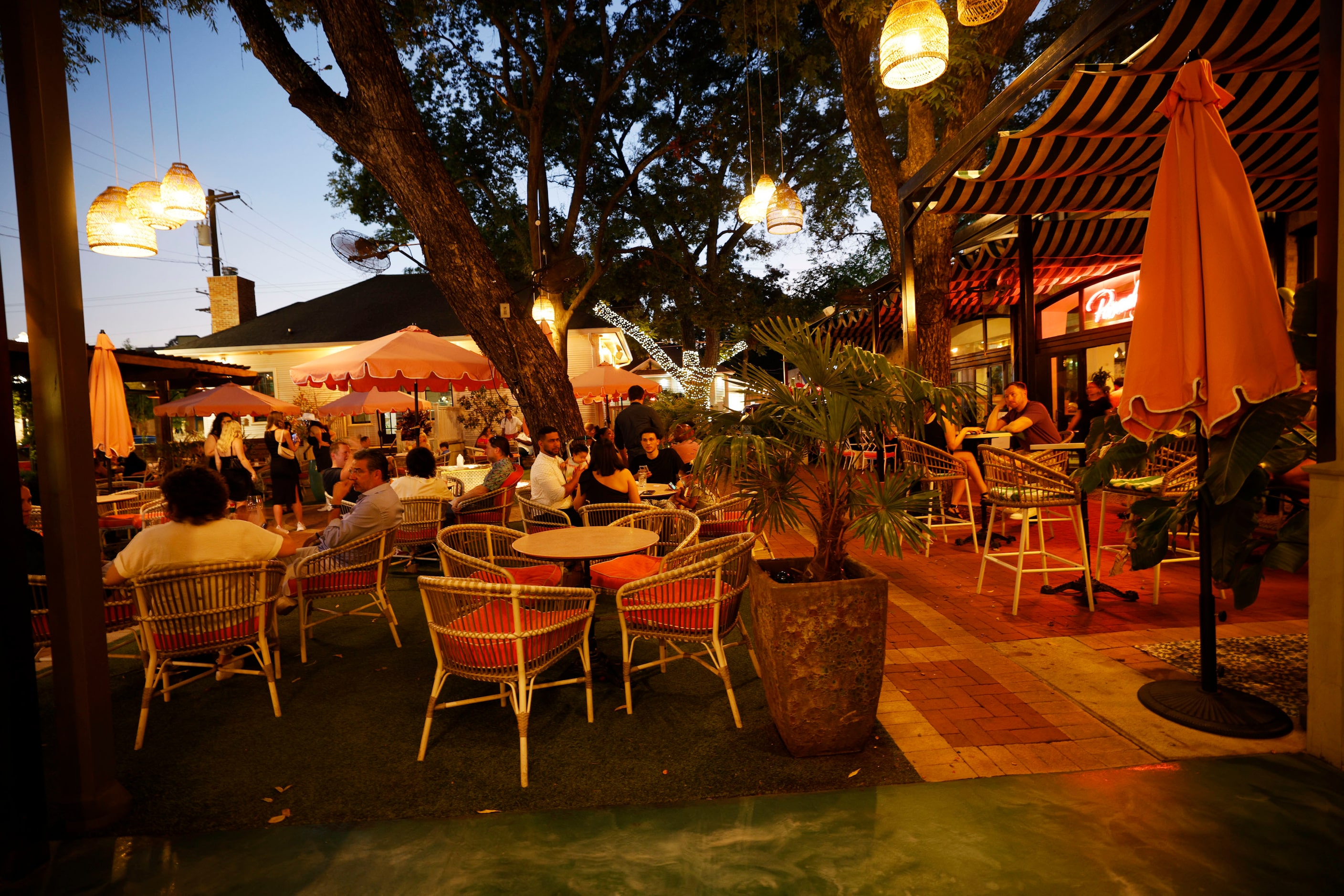 People sit on the patio at Paradiso in the Bishop Arts District in Dallas, Saturday, Sept....