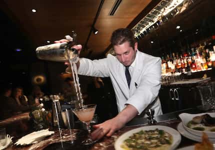 Andrew Ryan mixes a cocktail at Bacari Tabu. Cocktails are served in vintage barware and can...