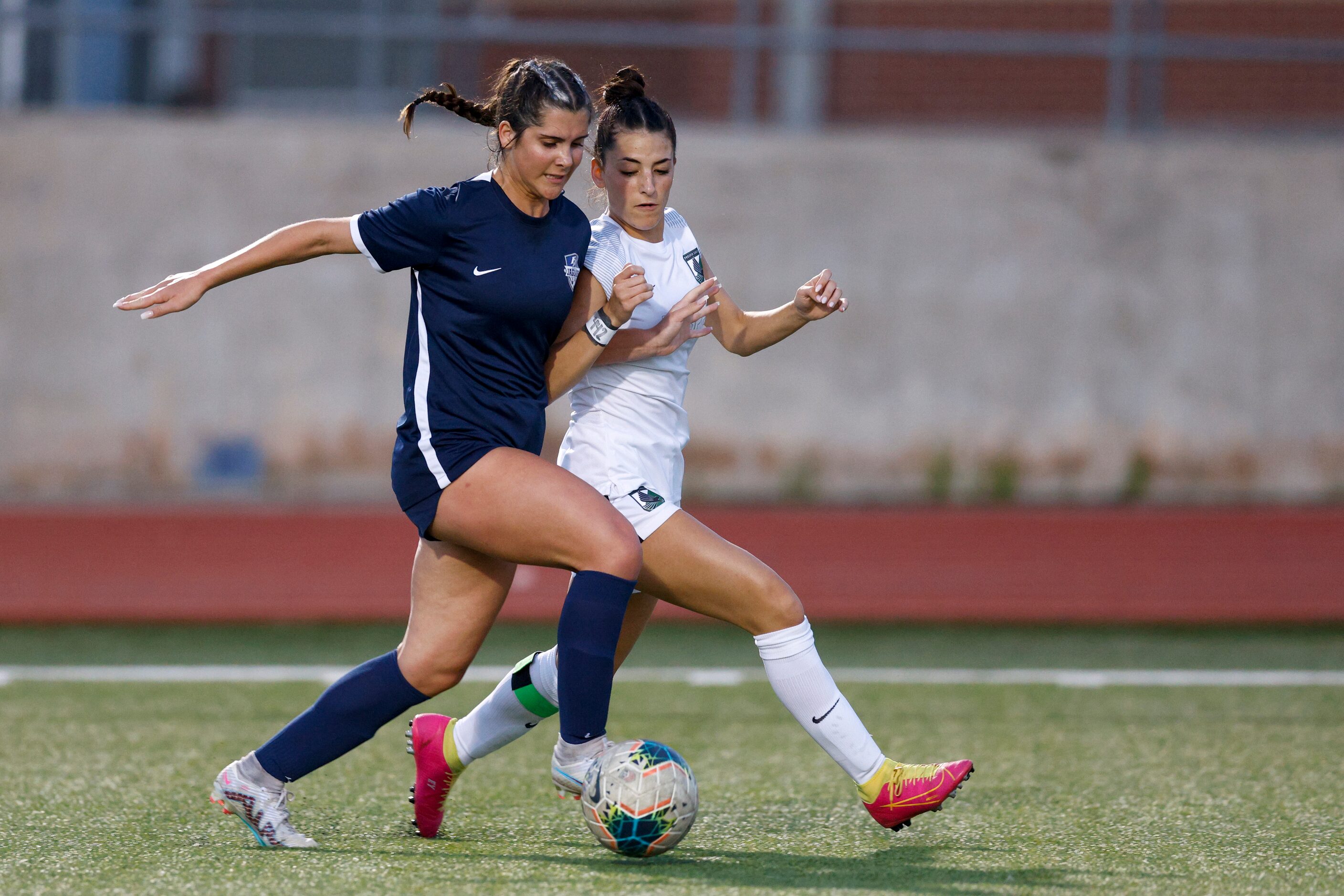 Flower Mound back Madison Vloitos (left) and Prosper midfielder Emma Yolinsky (11) battle...