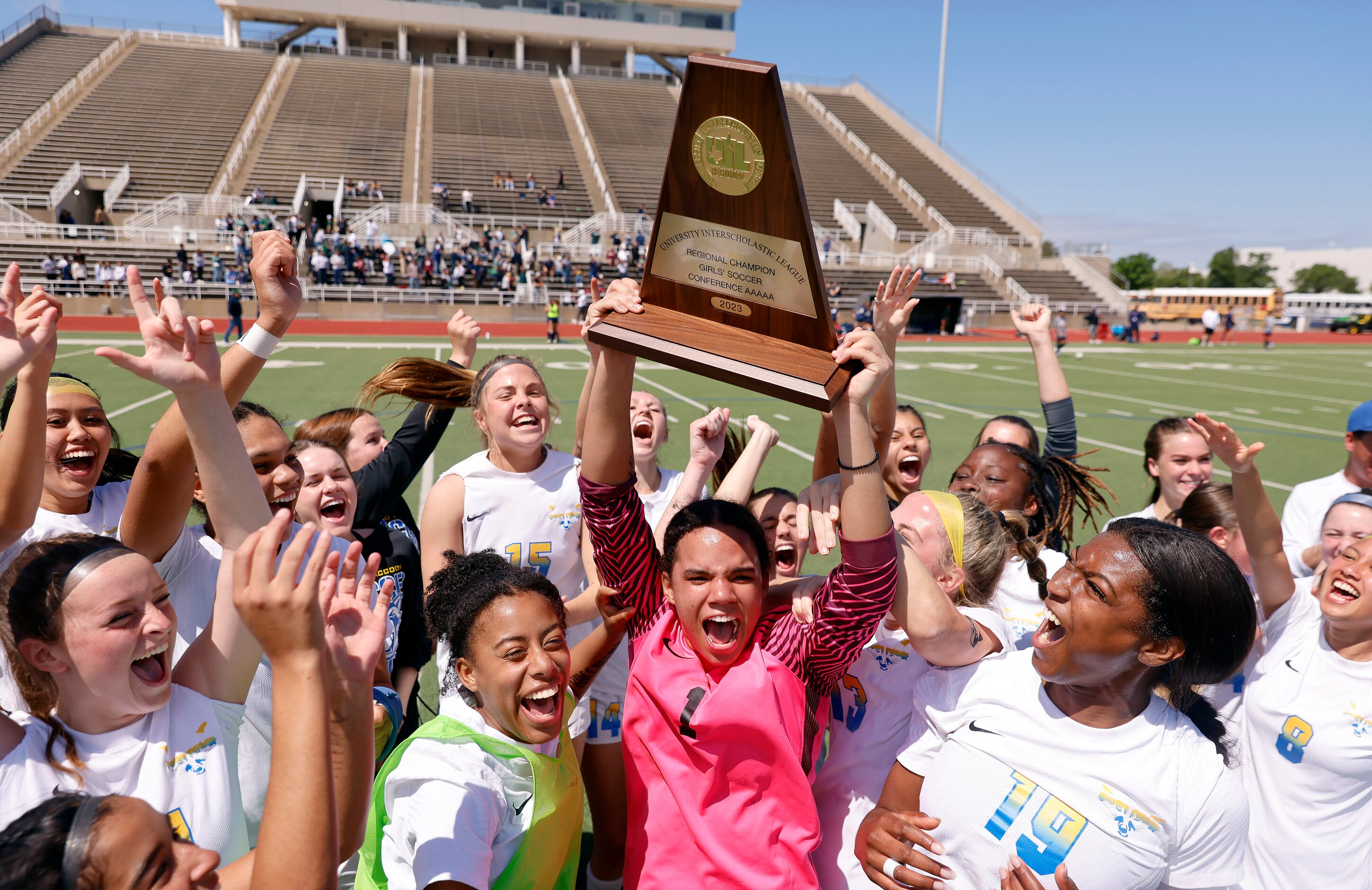 Frisco goalkeeper Ariana Anderson hoists the Class 5A Region II championship trophy after...