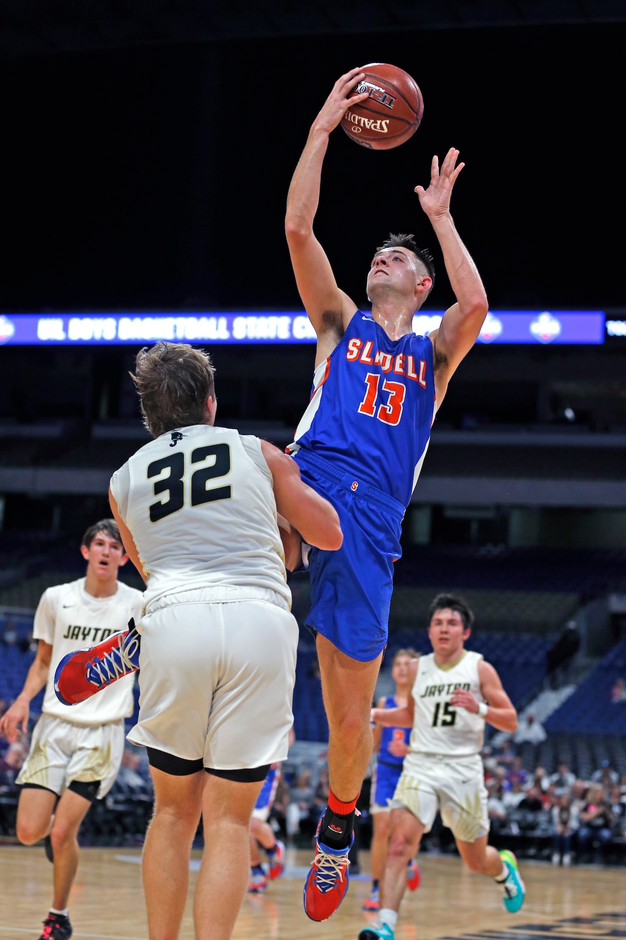 Slidell center Slayton Pruett #13 scores two over Jayton guard Tye Scogin #32 in a Class 1A...