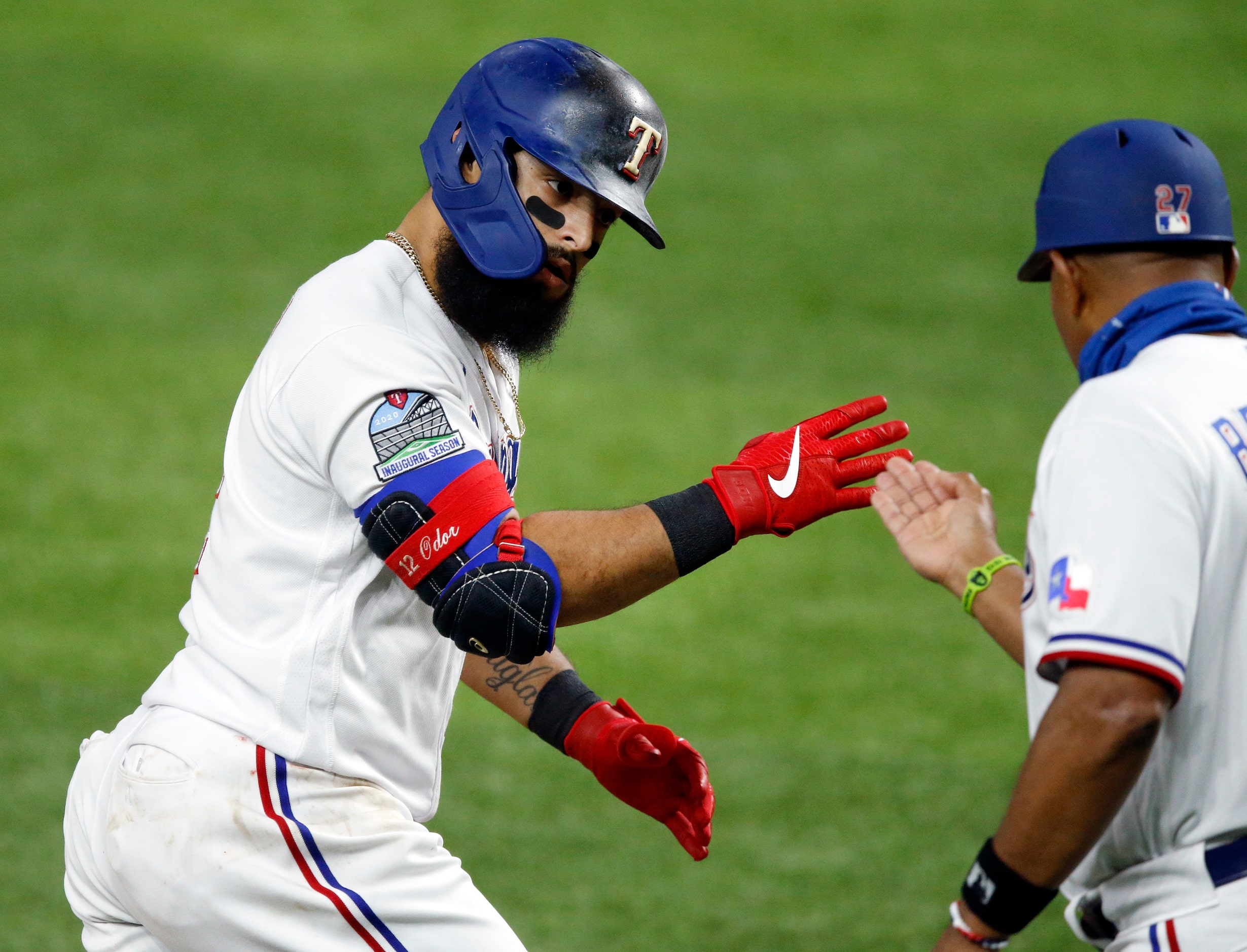 Texas Rangers second baseman Rougned Odor (12) salutes third base coach Tony Beasley after...