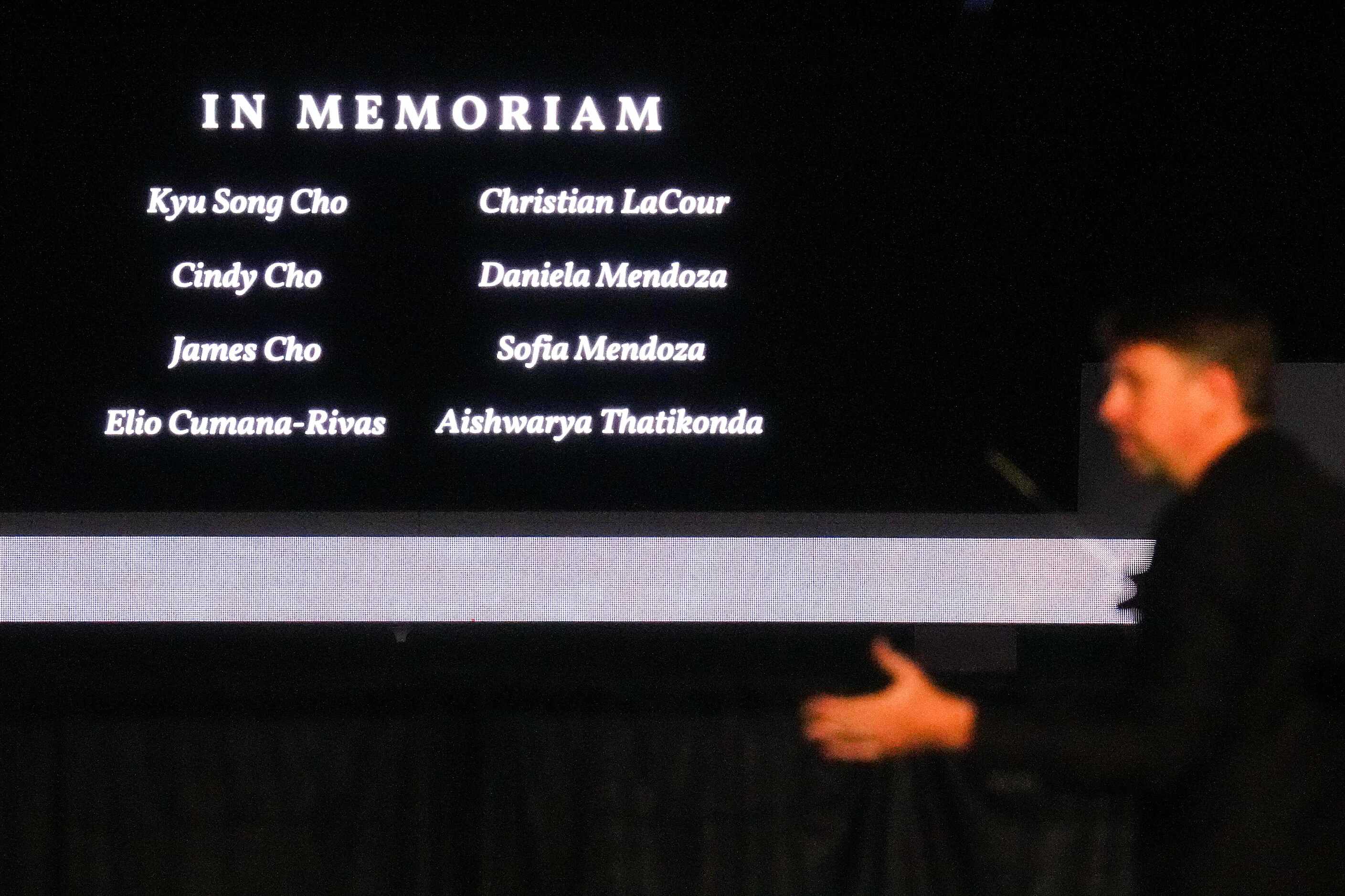 Names of the victims are shown on screens as the Allen Philharmonic Orchestra plays during a...