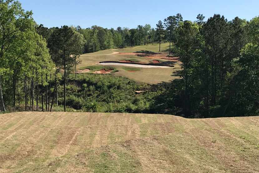 The dramatic par-3 12th hole at Tempest Golf Club in Gladewater, Texas, requires a shot over...