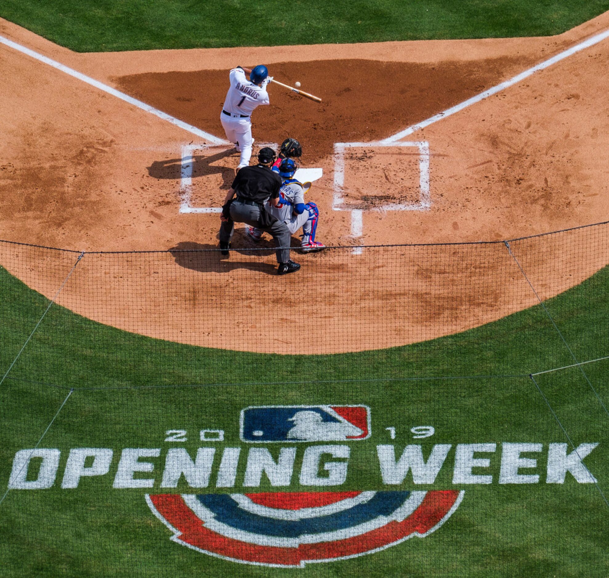 Texas Rangers shortstop Elvis Andrus connects for a single during the first inning against...