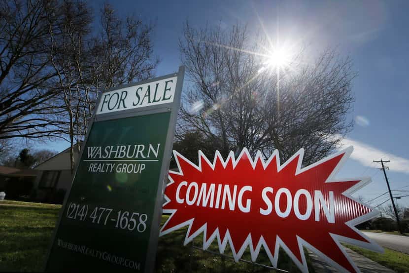 A real estate sign sits in front of a house in Richardson in February. Home sales in...