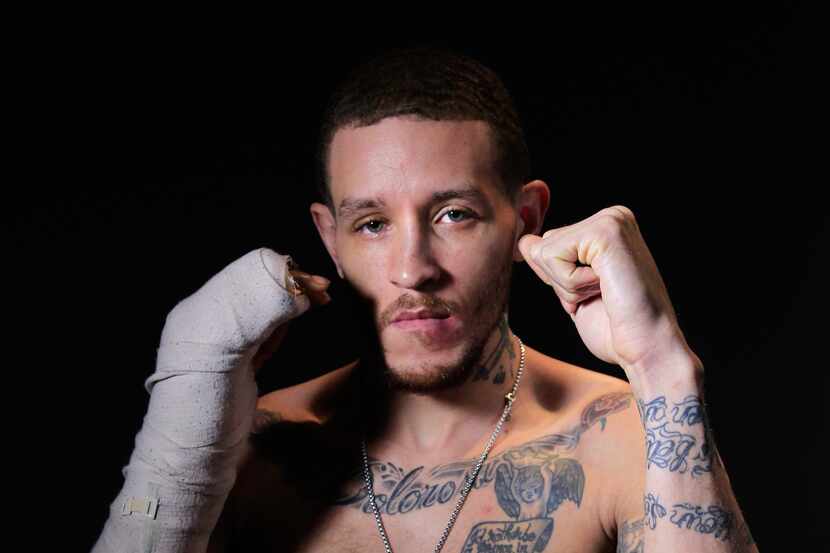 Mavericks guard Delonte West shows his tattoos at the American Airlines Center on Wednesday,...