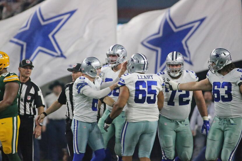 The Dallas offensive line is pictured after a score during Cowboys NFL football playoff game...