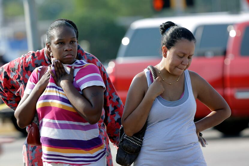 Parents LaKesia Brent (left) and Eunice Pacheco wait for news about their children Wednesday...