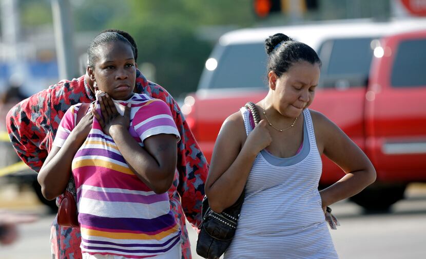Parents LaKesia Brent (left) and Eunice Pacheco wait for news about their children Wednesday...