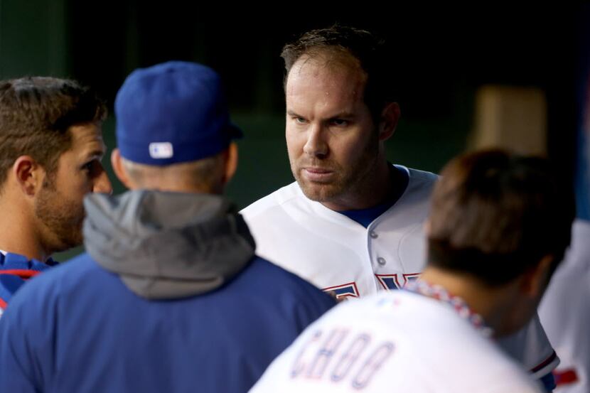 Texas Rangers starting pitcher Colby Lewis (48) talks with catcher J.P. Arencibia (7) and...