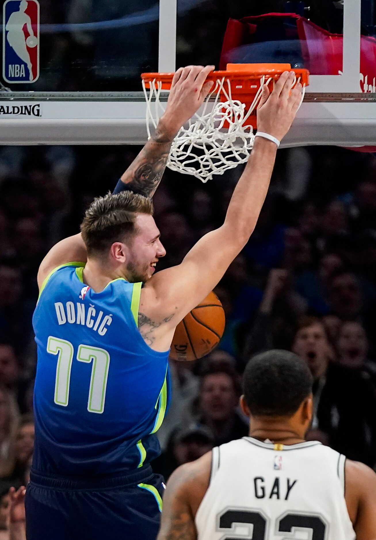 Dallas Mavericks guard Luka Doncic (77) dunks the ball over San Antonio Spurs forward Rudy...