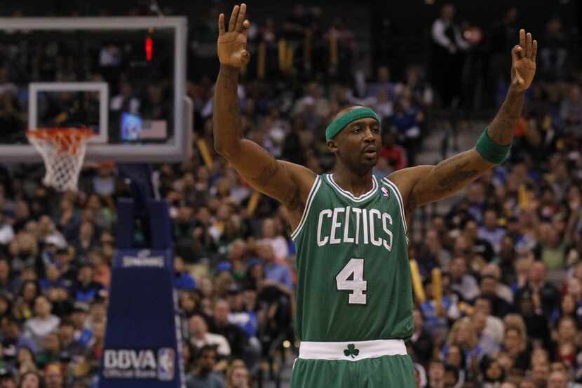 Boston Celtics player Jason Terry, celebrates a three-point shot by a teammate as they...