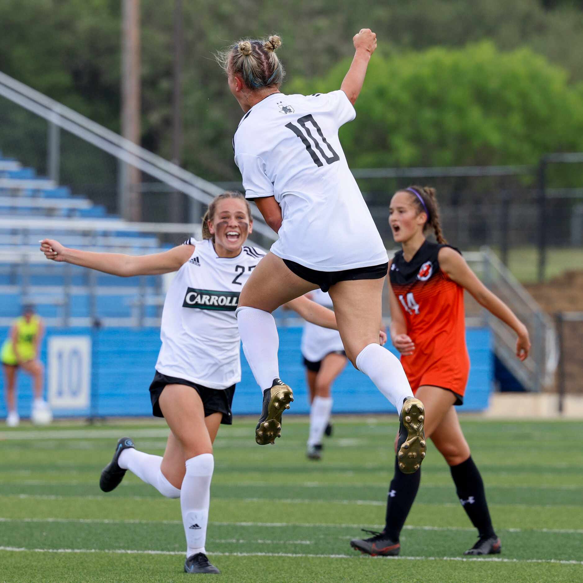 Southlake Carroll midfielder Kennedy Fuller (10) celebrates her girl with midfielder Laney...