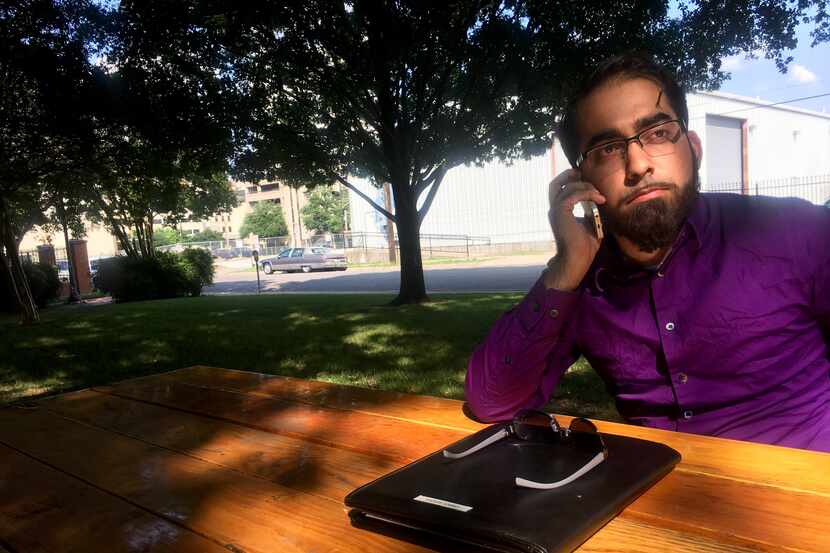 Omair Saddiqi talks on the phone with police Thursday in between media interviews.