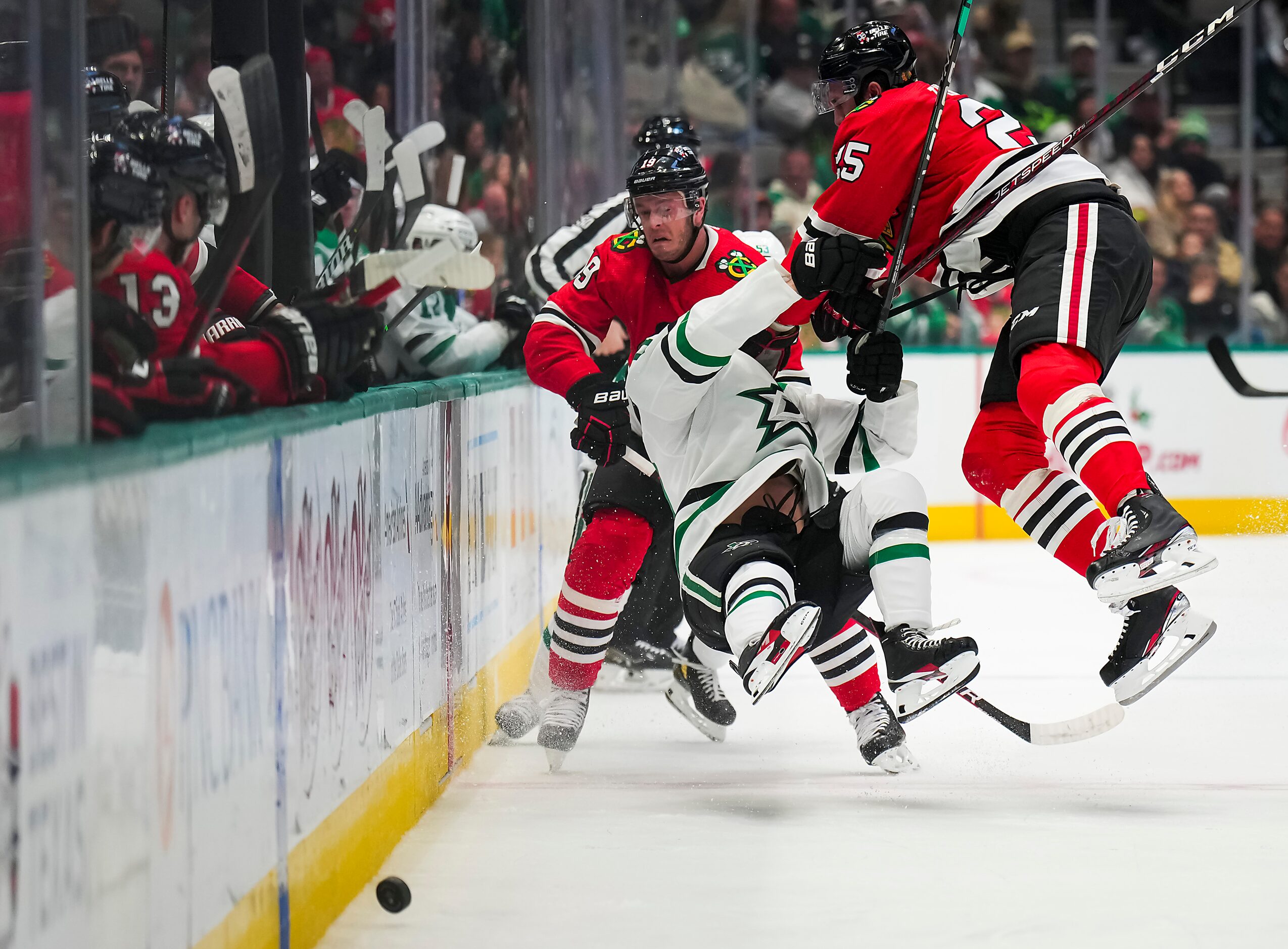 Dallas Stars center Ty Dellandrea (10) is knocked to the ice by Chicago Blackhawks...