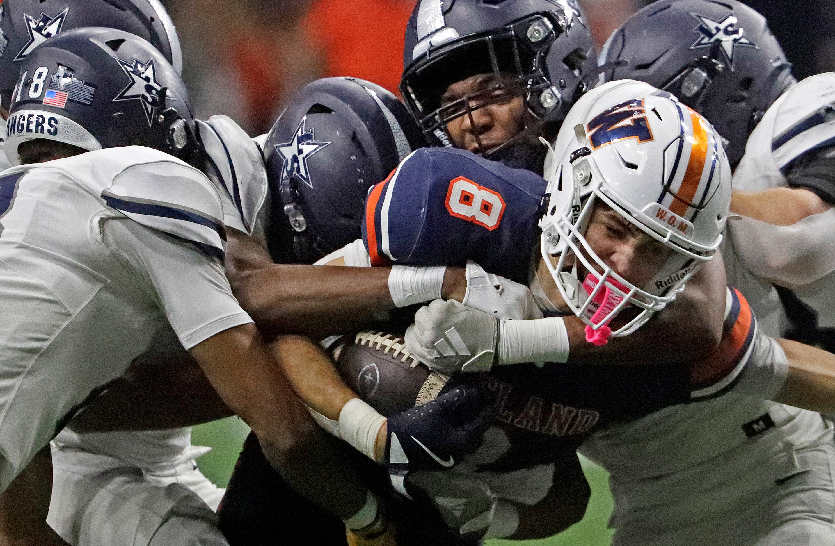 Wakeland High School wide receiver Ryder Treadway (8) is wrapped up by the Lone Star High...