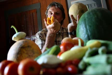 Ed Lowe, owner of Celebration restaurant on Lovers Lane, shows the flesh of a sweet Texas...