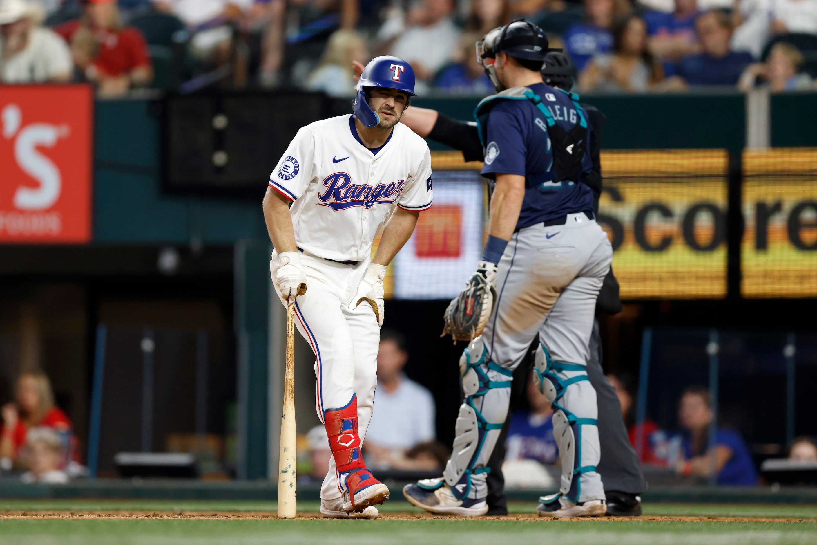 Texas Rangers shortstop Josh Smith (8) reacts after fouling a pitch off his foot during the...