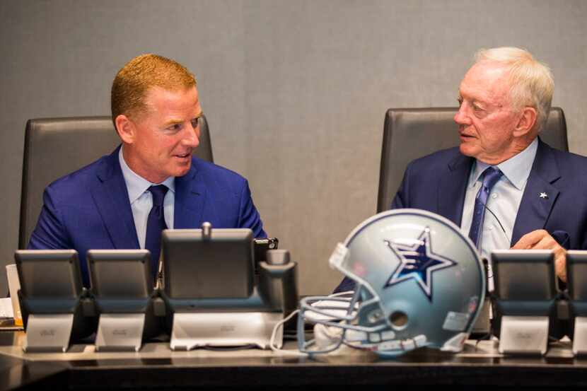 Dallas Cowboys head coach Jason Garrett talks with owner Jerry Jones in the war room during...