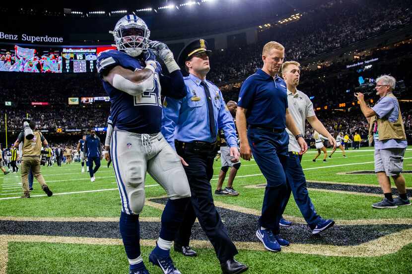 Dallas Cowboys running back Ezekiel Elliott (21) and head coach Jason Garrett leave the...