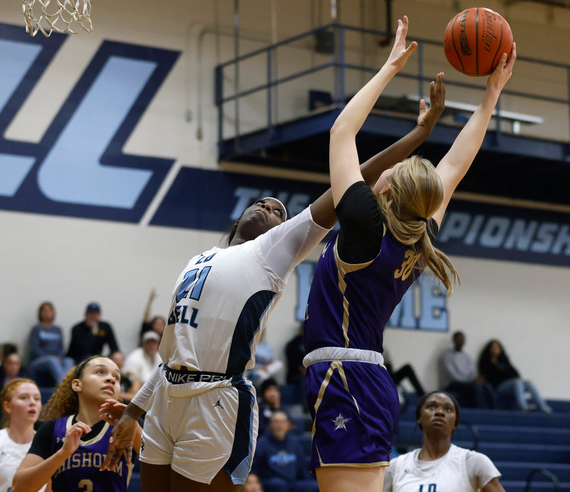 Hurst L.D. Bell forward Gracie Oma (21) and  Saginaw Chisholm Trail center Claire Blakley...