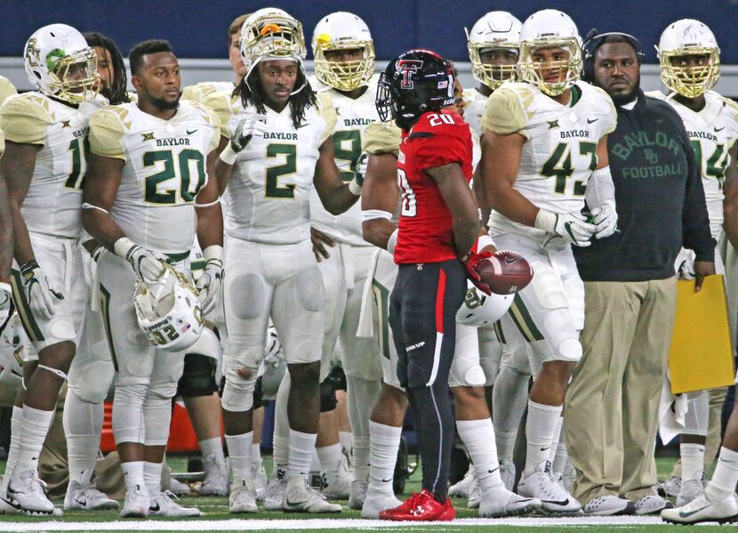 Texas Tech receiver Keke Coutee (20) gets the strs-down from a group of Baylor players after...