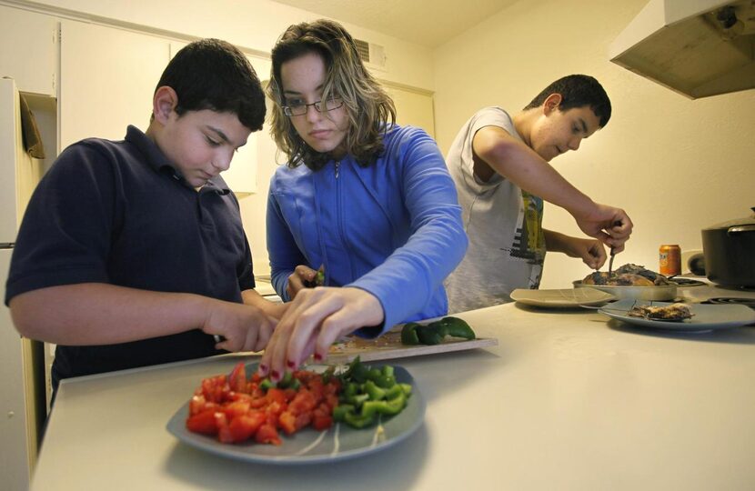 Furat Ali Mohammed (left),  Wiaam Ali Mohammed and Khalid Ali Mohammed prepared dinner for...