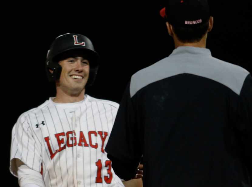 Mansfield Legacy infielder Nathan Rooney (13) was all smiles with head coach Chris McMullen...