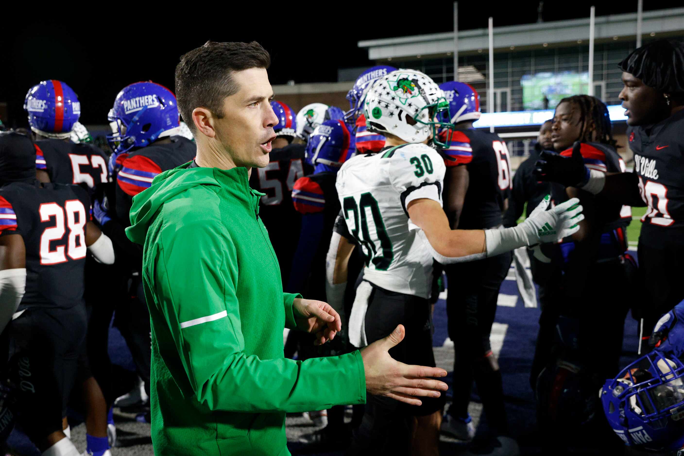 Southlake Carroll head coach Riley Dodge greets members of the Duncanville team after their...
