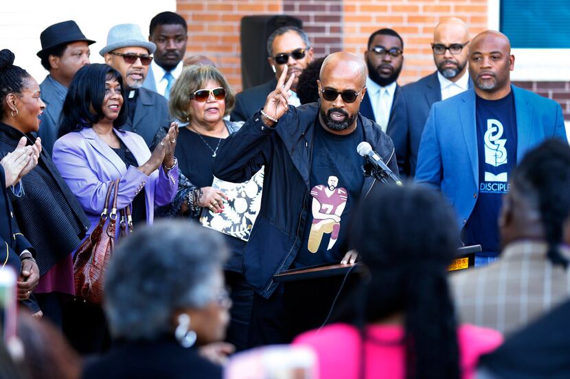 Dr. Frederick D. Haynes III flashes the peace sign after speaking before several other...