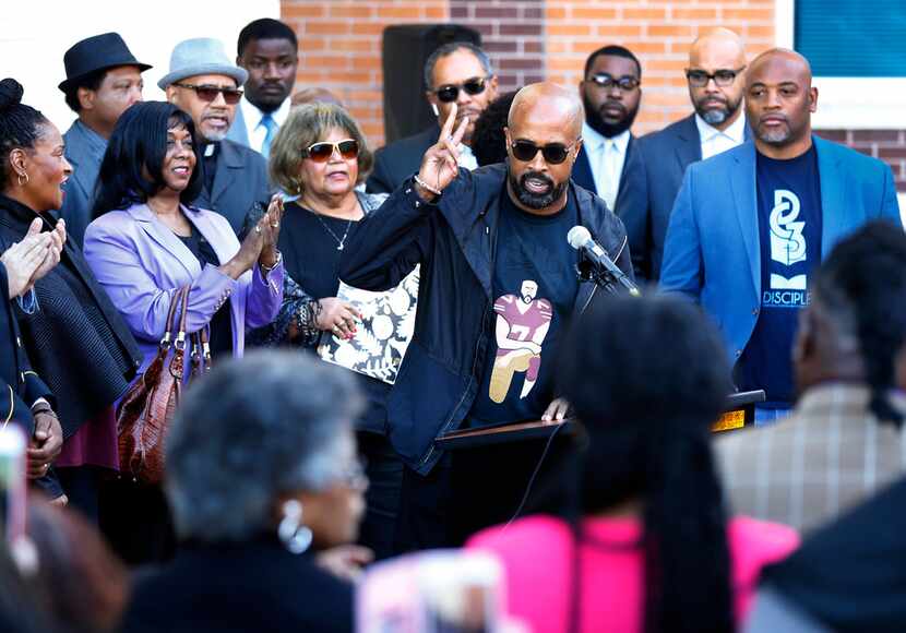 Dr. Frederick D. Haynes III flashes the peace sign after speaking before several other...