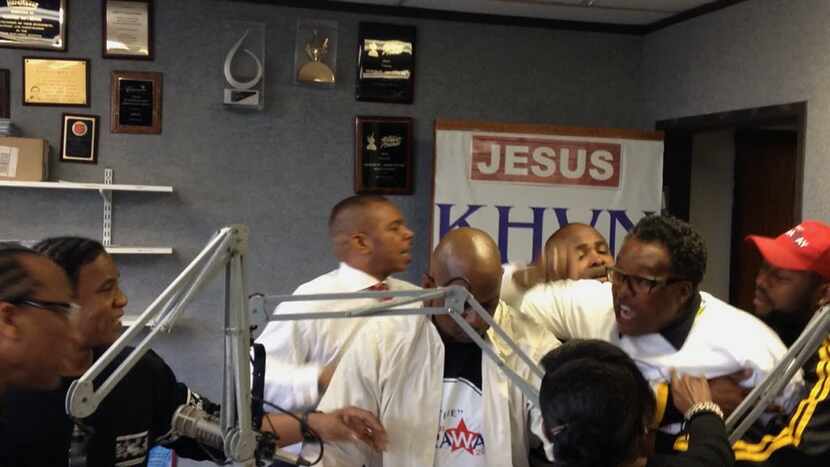 Two men are seen holding back Dwaine Caraway from John Wiley Price in a video of an incident...
