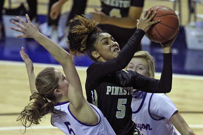 Victoria Flores (5), center, puts up a shot for Pinkston during the Texas UIL Girls 4A state...