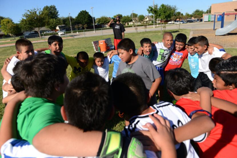 The fourth and fifth grade soccer players get into a huddle during the team's practice at...