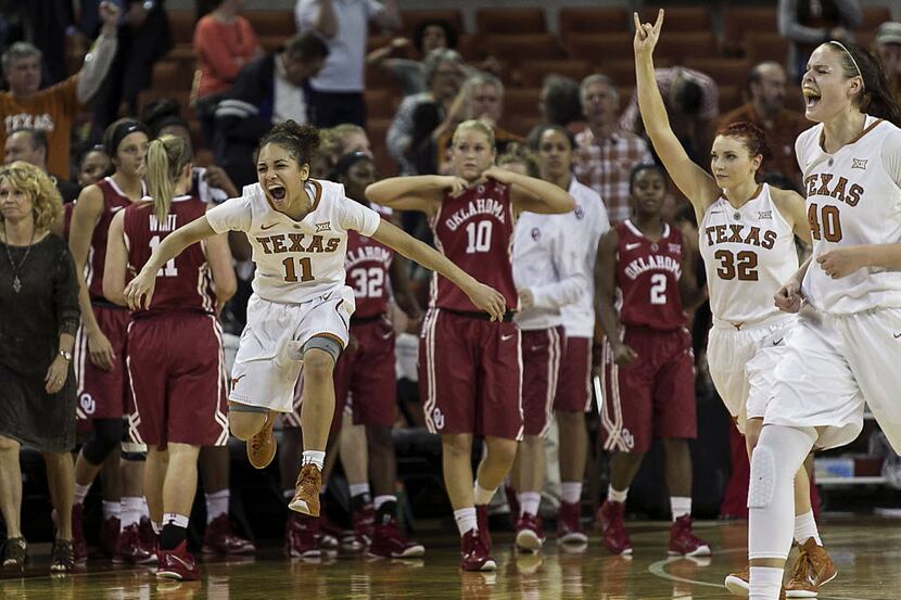 Texas Brooke McCarty (11), Brady Sanders (32) and Kelsey Lang (40) left to right, celebrate...
