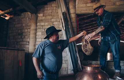 Gracias a Dios mezcalero Oscar Hernandez hands the basket containing the brisket and other...