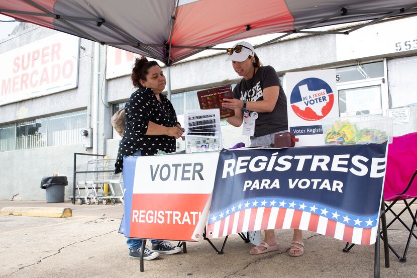 Emma Coronado Valdez, left, registers as a first-time voter with the assistance of League of...
