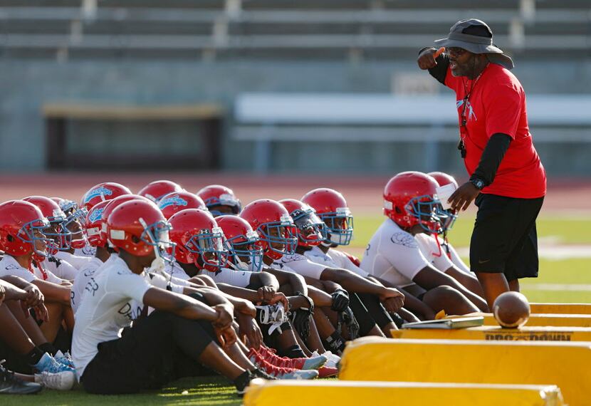 Head football coach Patrick Williams talks to his team during the first day of football...